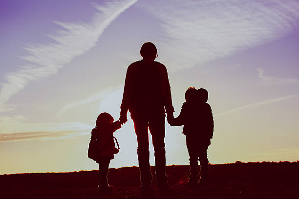 istock father with two kids travel at sunset 617748526