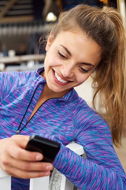 istock Smiling woman messaging on mobile phone 617751040