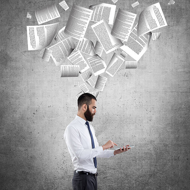istock Businessman using digital tablet in front of wall 617751278