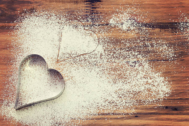 istock Heart of white flour on a brown board 617751590