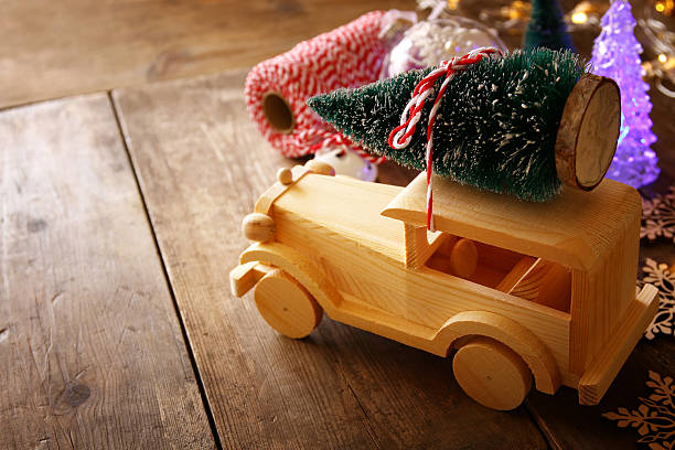 istock Wooden car carrying a christmas tree 617751856