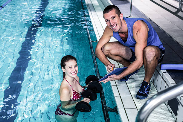 istock Smiling fit woman doing aqua aerobics 617752276