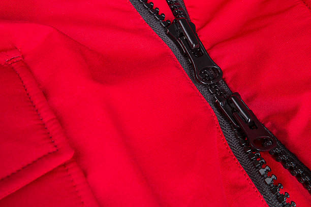 istock Fragment of red jacket with black zipper. ziplock background 617753026