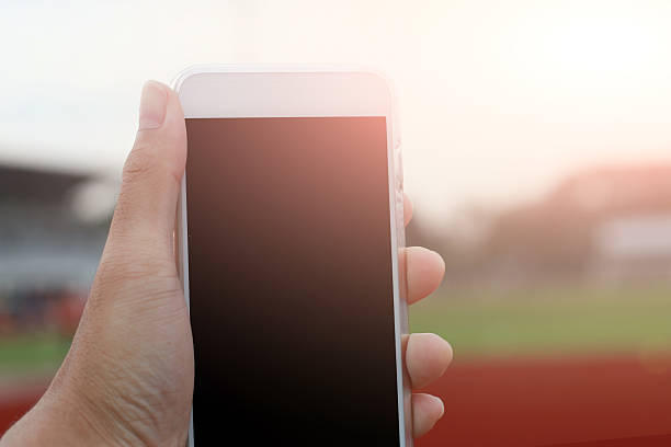 istock Hand holding phone isolated on black clipping inside 617753800