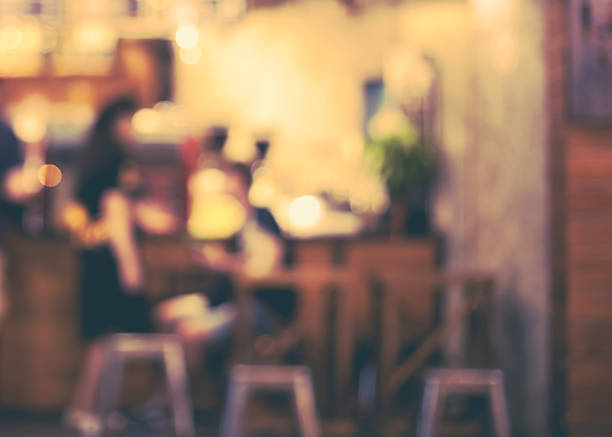 istock Girl and boy talking in front of a open cafe 617754314