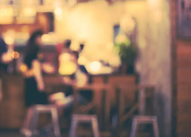 Photo of Girl and boy talking in front of a open cafe