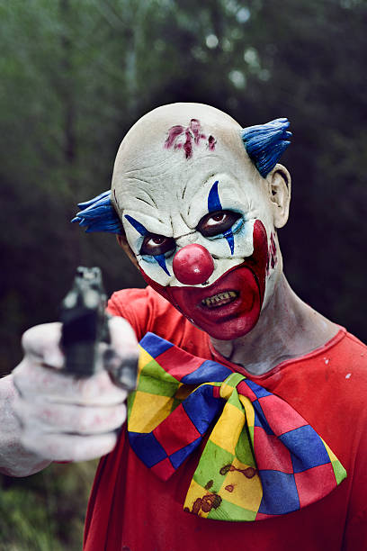 istock scary evil clown with a gun 617755292