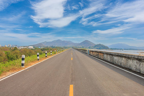 istock roadway for transportation with mountain and green grass, transp 617756112