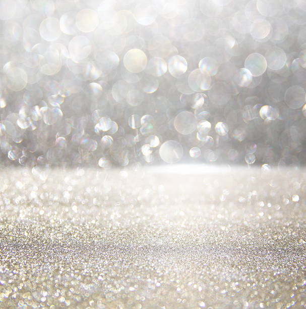 istock glitter vintage lights background. silver and white 617757498