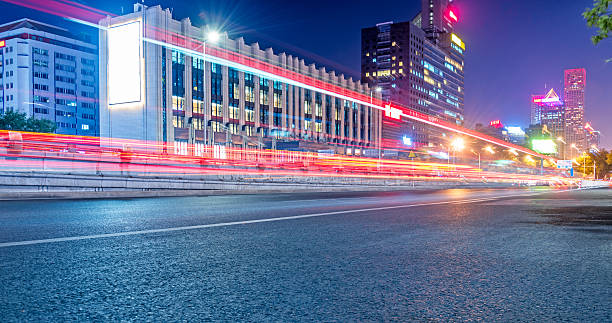 istock blurred traffic light trails on road at night 617758420