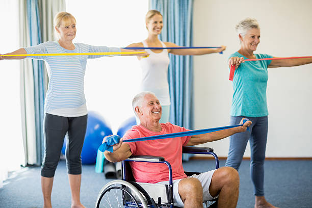 istock Seniors exercising with stretching bands 617758600