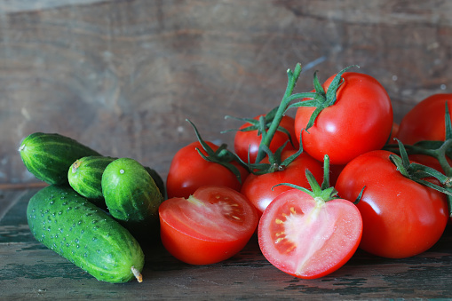 branch of tomatoes on wooden background