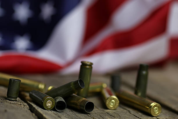 istock bullet and usa flag in the sand war 617760724