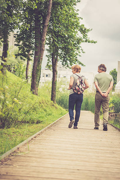 istock Senior caucasian couple walking outdoors back view 617761348