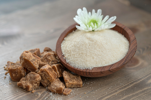 coconut flower sugar and brown sugar on wooden background