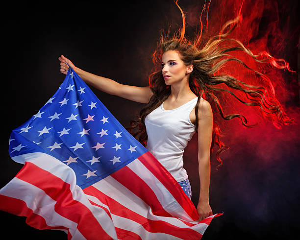 Girl holding US flag on a flagpole