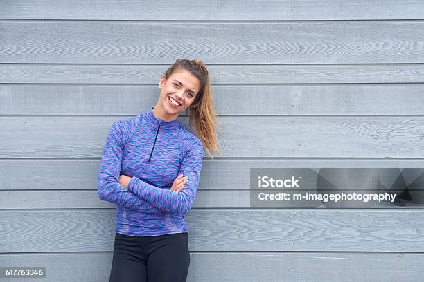 Smiling Active Woman Standing With Arms Crossed Stock Photo - Download Image Now - Exercising, Healthy Lifestyle, One Woman Only