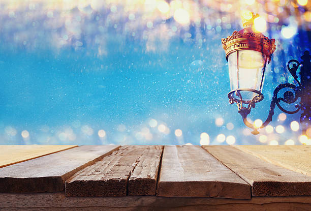 istock Empty table in front of abstract Christmas street lights 617763632