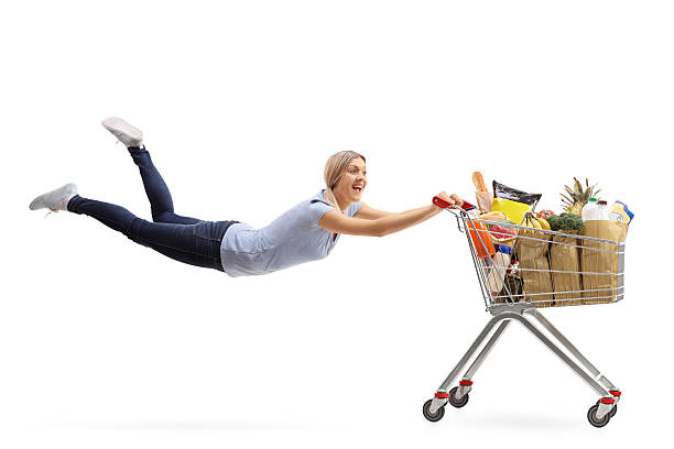 istock Woman being pulled by a shopping cart 617766228