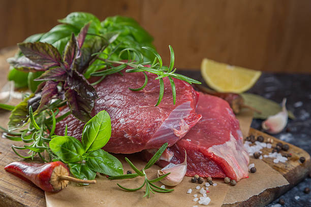 istock Raw beef meat with herbs and spices 617766628
