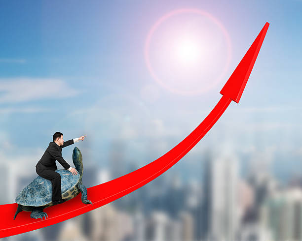 istock Businessman riding turtle on red arrow up 617766866