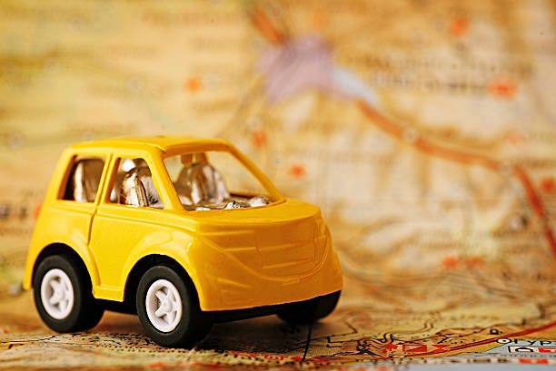 istock Yellow children's car on map background 617766918