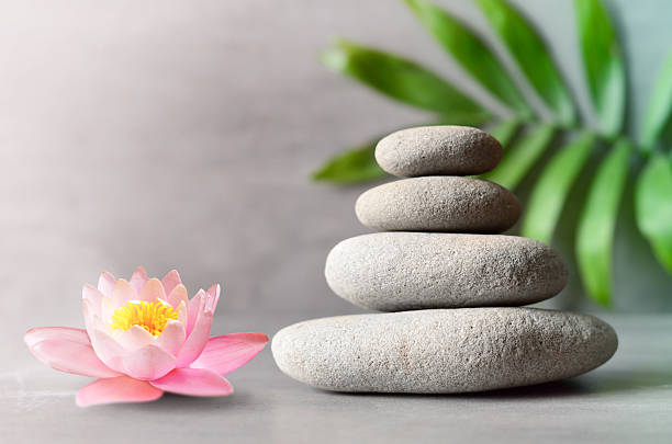 istock Spa stones with flower lily on light background 617767576