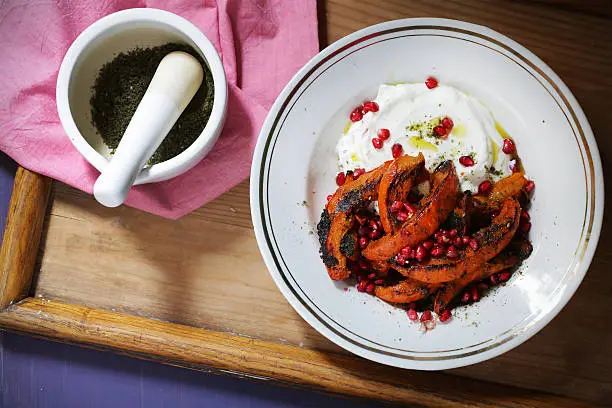 Photo of Yogurt with baked pumpkin, zaatar and pomegranate, healthy