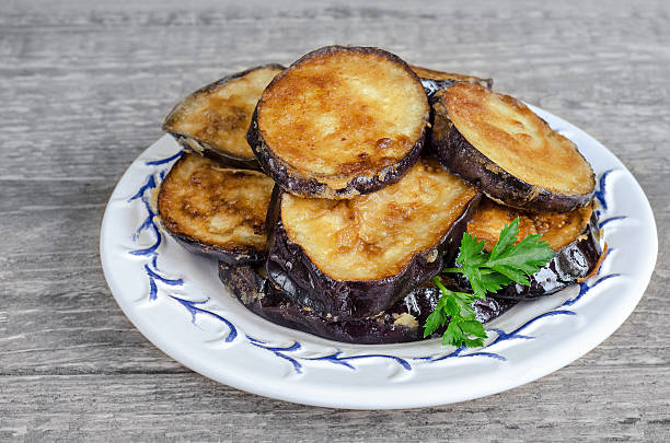 istock Fried eggplant, on the plate and a gray wooden background 617768120