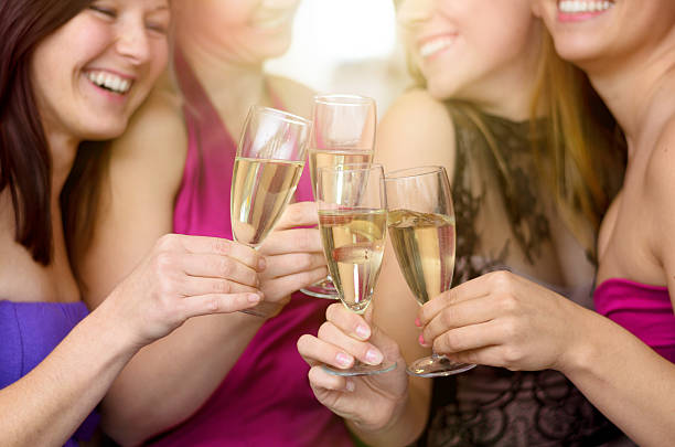 istock Laughing merry young women toasting together 617768296