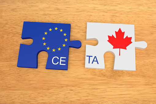 CETA: EU and Canada Flag Puzzle Pieces On Wood, 3d illustration