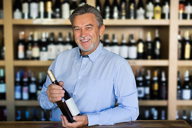 istock Man working in wine shop 617777106