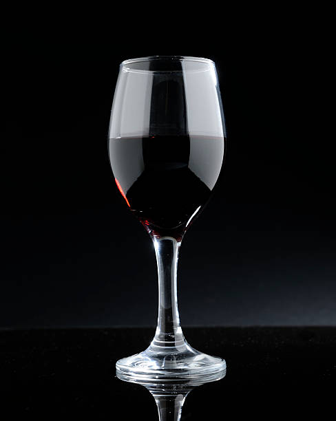 istock glass of red wine on a dark background 617777498