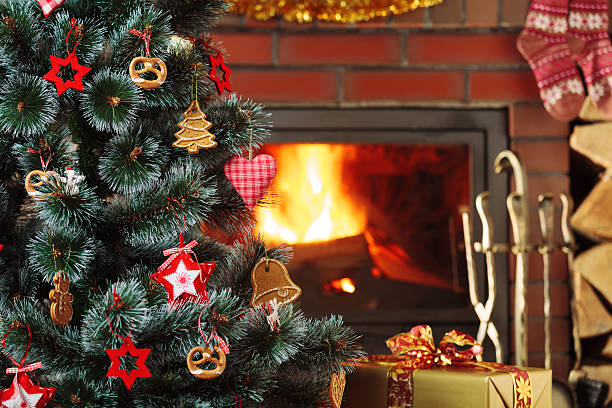 istock Christmas decorations hung on the tree. Blazing fireplace in the 617777772