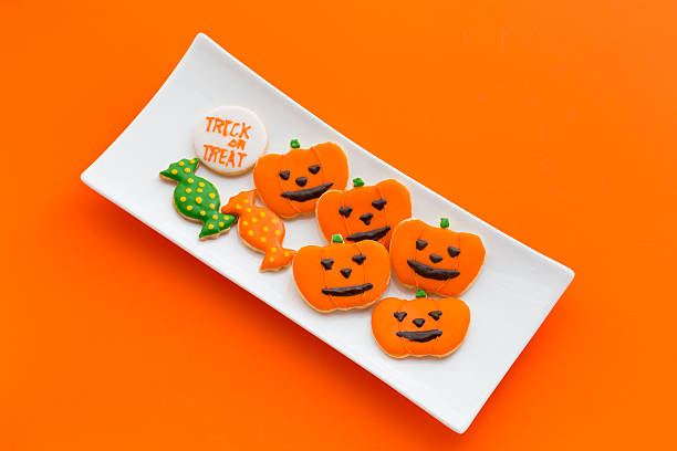 istock Halloween cookies on orange background 617778534