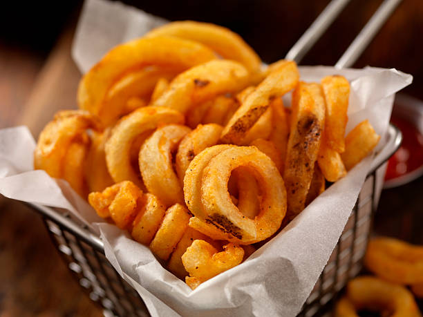 Basket of Curly French Fries Basket of French Fries-Photographed on Hasselblad H3D2-39mb Camera curly fries stock pictures, royalty-free photos & images