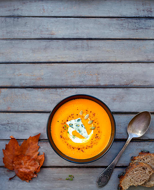 istock Pumpkin soup a wooden table. 617779436