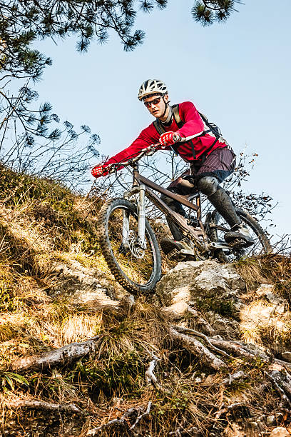 istock Extreme mountainbiker on steep trail 617779470