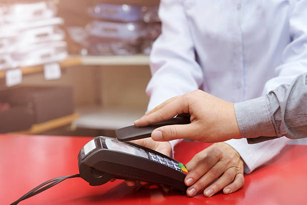 istock Man making contactless payment with smartphone 617779718
