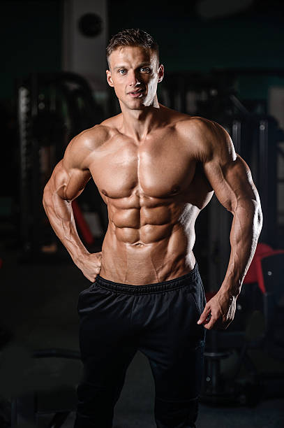 istock Strong athletic man fitness model showing six pack abs 617780052