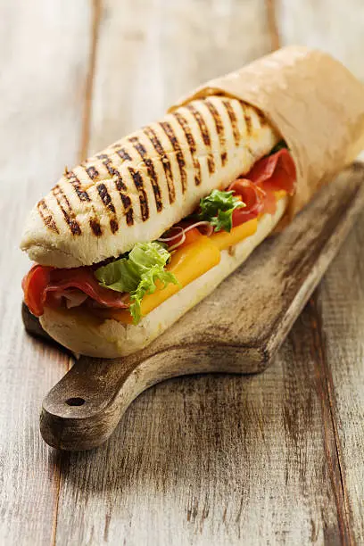Traditional Italian sandwich with ham and cheese served warm.