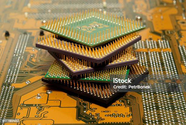 Stack Of Cpu Processors And Circuit Board Motherboard Stock Photo - Download Image Now