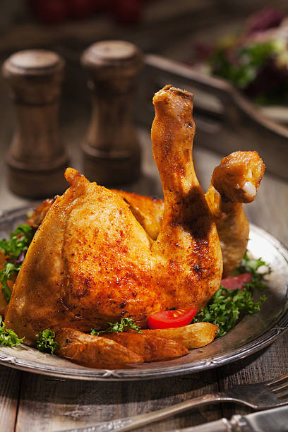 istock Baked chicken leg, served with roasted potatoes and vegetables. 617781088