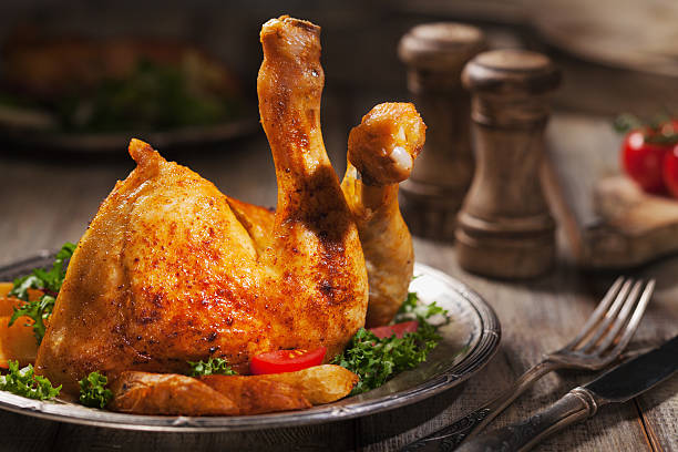 istock Baked chicken leg, served with roasted potatoes and vegetables. 617862736