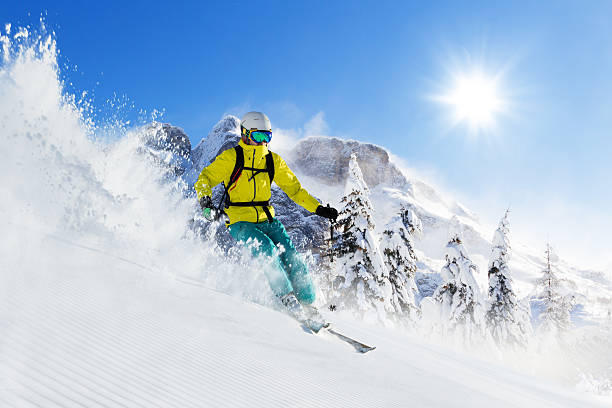 istock Skier on piste running downhill 617863092
