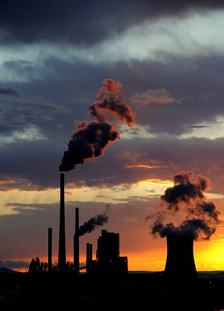 istock Coal power station with smoking chimneys in sunset 617863764