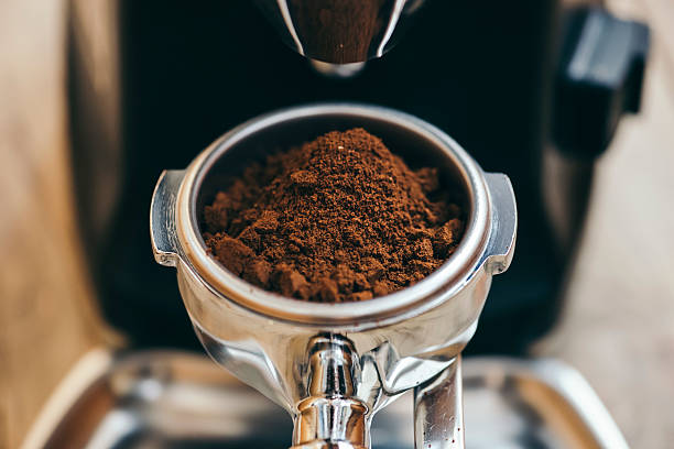 istock Freshly ground coffee beans in the portafilter 617864362