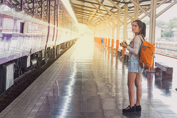 istock Backpack and camera at the train station with a traveler 617864452