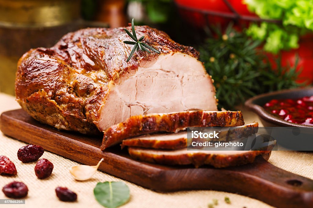Roast pork with cranberry dip, basil, coriander and rosemary. Pork Stock Photo