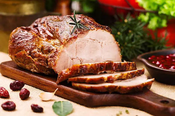 Roast pork with cranberry dip, basil, coriander and rosemary.